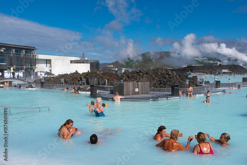 Tableau sur toile Blue Lagoon geothermal spa in Iceland with people relaxing in warm blue water