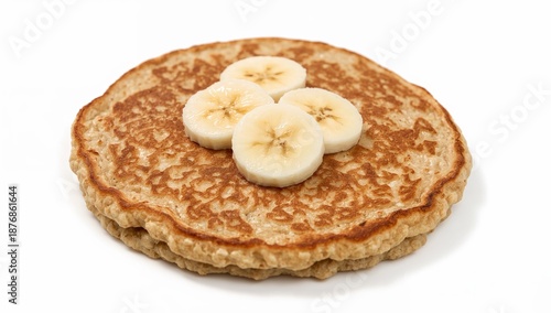 Vegan banana oat pancake topped with fresh banana slices on white background, healthy plantbased breakfast concept