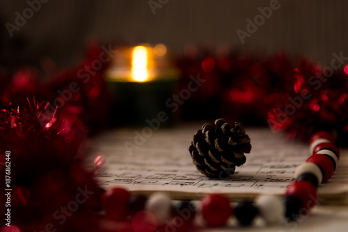 christmas still life with red garland sheet music