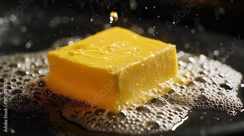 Cube of Butter Melting on Hot Frying Pan Time Lapse Video.