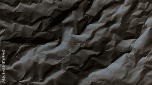 Crumpled black paper texture background closeup detail