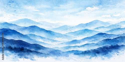 A beautiful winter mountain landscape under a bright blue sky where white clouds and fog drift over the peaks in the light of a clear day