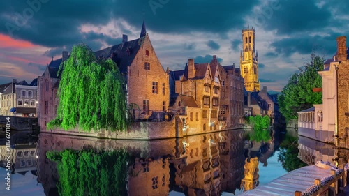 Brugge, Belgium. Cityscape from famous Rozenhoedkaai viewpoint at dusk (static image with animated sky and water)
