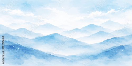 A breathtaking blue sky with white clouds over a snowy mountain landscape at sunrise reveals a mist-covered valley and hills under a winter dawn horizon