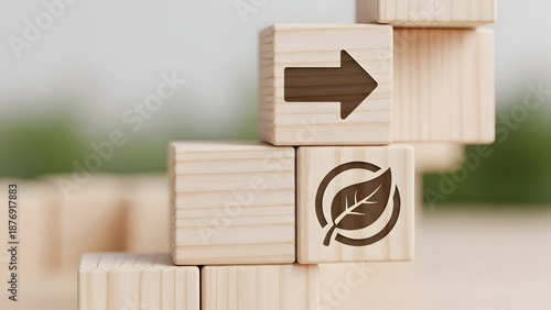 Wooden blocks showing arrow and eco leaf icon, direction toward sustainability concept,