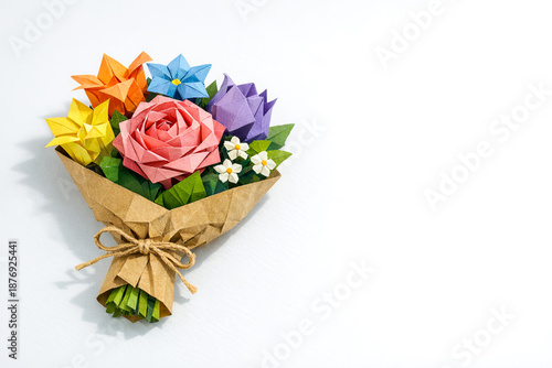 Colorful origami flower bouquet arranged in paper wrapping with ribbon  