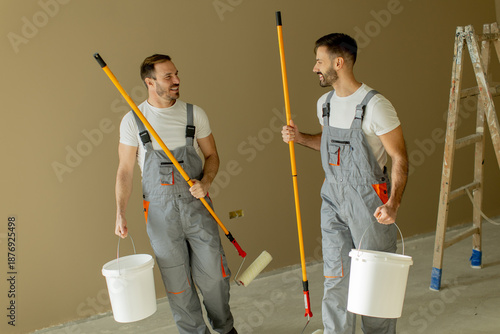 Two men prepare for paintin...