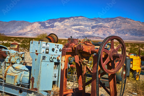 Quadro em tela Rusty Industrial Machinery Desert Landscape and Mountain View in Harsh Sunlight