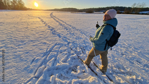 Mature woman skiing on trail in winter cold weather. Cross-country skier in snowy National park Sumava, Czech Republic.