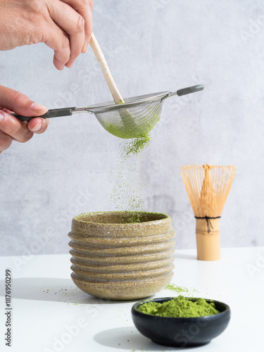 Sifting matcha green tea powder into chawan