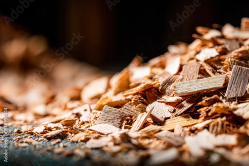 Detailed close up of a pile of mixed oak and pine wood chips on a clean surface, showcasing their texture and color variations.