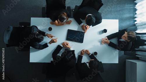 Quadro su tela Top down aerial view of group of business people looking at financial chart while analyze and explain growing stock market statistic