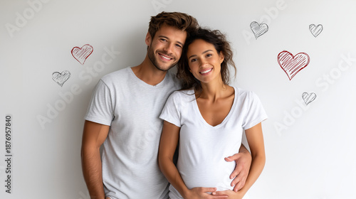 a happy pregnant couple standing on a clean white background, husband gently hugging and supporting his pregnant wife