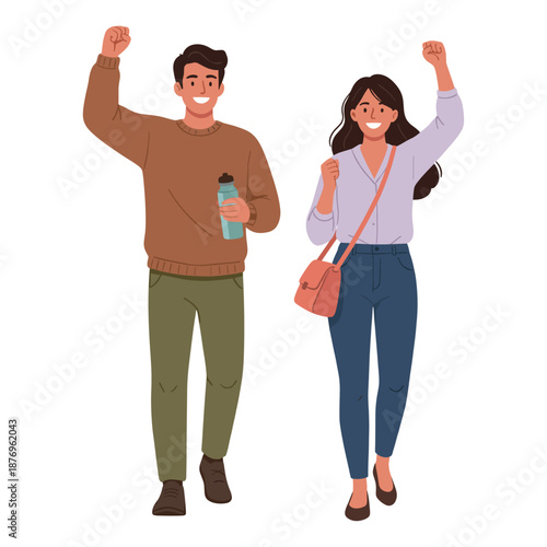 Smiling man and woman celebrating with raised fists