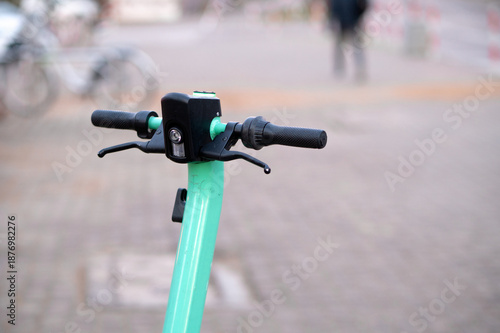 Close-up of the top part of a shared electric scooter. Urban transportation, modern mobility, city lifestyle, and eco-friendly urban commuting.