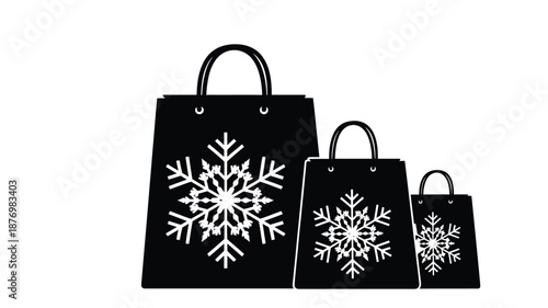 Obraz na plátne Black shopping bags with white snowflake designs varying in sizes on a white bac