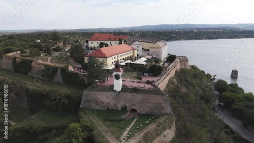 Travel concept. Aerial view of european city with architecture buildings and streets. Petrovaradin Novi Sad fortress along the Danube river. Vertical shot