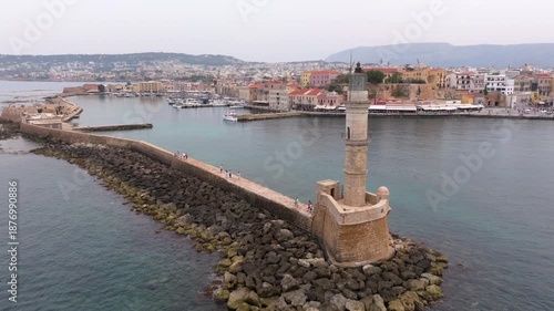  View of Chania with the amazing lighthouse, mosque, venetian shipyards, Crete, Greece.Waves crashing on lighthouse, Beautiful Greece and best scenic places - panorama