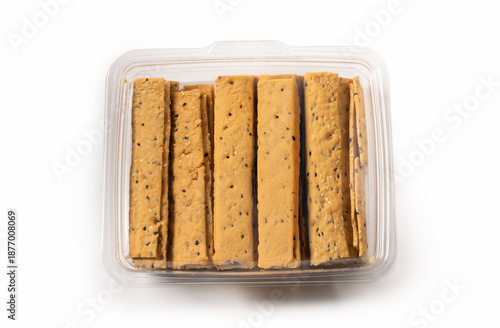 Seed crackers sticks in plastic container isolated on white background
