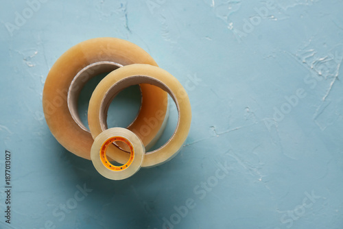 Adhesive tape rolls on blue...