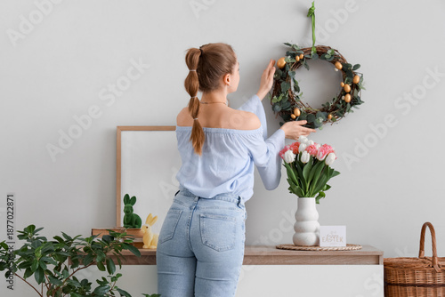 Young woman hanging Easter ...