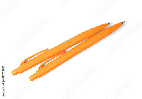 Orange pens on white backgr...