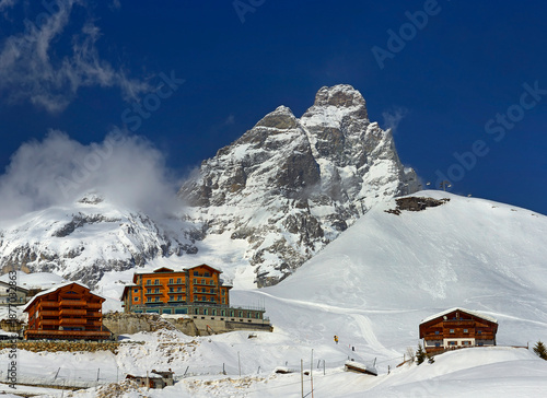 Scenic view on Matterhorn peak - Monte Cervino from Breuil-Cervinia. Mountain situated on the border between Switzerland and Italy, over the Swiss Zermatt and the Italian town of Breuil-Cervinia.