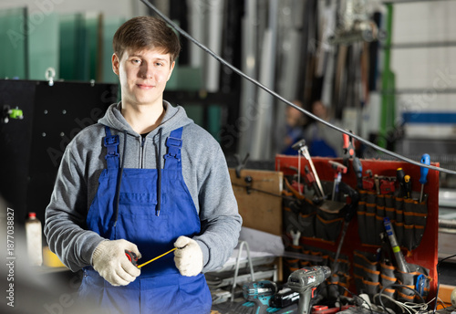 Valokuva During work process, guy employee produces blanks for repairs and interior decoration