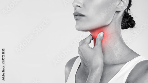 фотографія Closeup of sick woman having sore throat, touching her neck with red inflamed zo