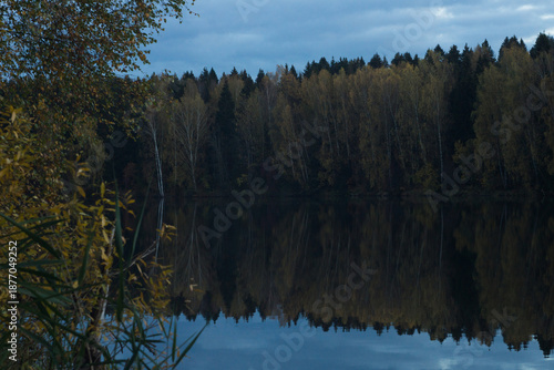 beautiful lake with forested shores in the October day
