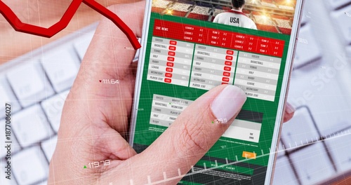 Tapping right hand holding phone scrolling sports UI over white keys showing LIVE tags and data
