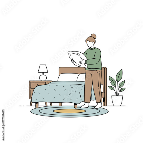 Woman making bed in bedroom holding pillow domestic routine.