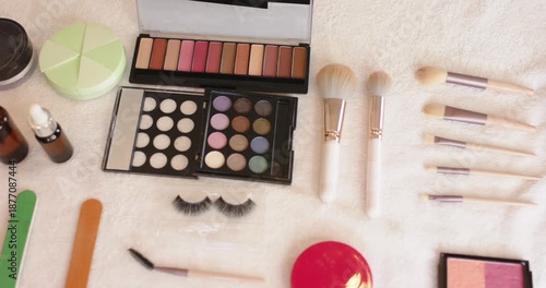 When camera is panning right, makeup palette and brushes are being revealed to showcase flat lay