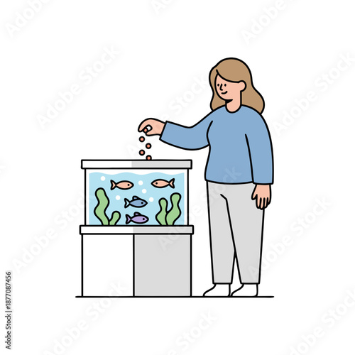 A woman feeding her pet fish in a home aquarium.