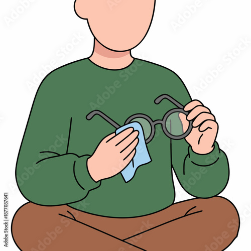 Person cleaning eyeglasses with a cloth focused on maintaining clear vision.
