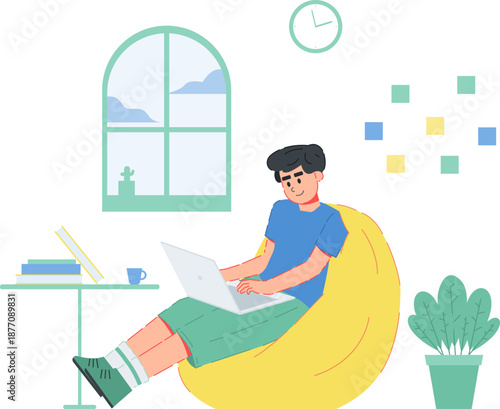 young man working on laptop while sitting on bean bag chair at home
