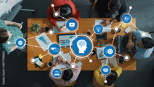 Photos Engaging aerial shot of a diverse team brainstorming AI concepts, leveraging modern technology in a collaborative workspace filled with innovative ideas and tools