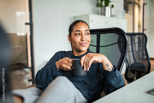 Young entrepreneur enjoying coffee break in startup office