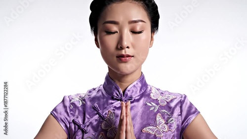 Asian woman in cheongsam meditating with closed eyes for inner peace mindfulness