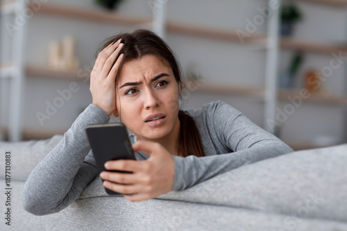 Photography Shocked upset anxiety worry european millennial female going through breakup, saddened by bad news in message, free space