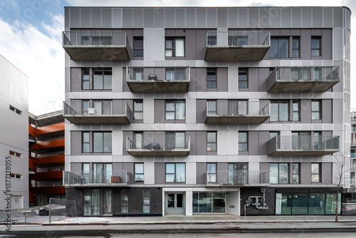 High-quality photo set of a contemporary urban apartment highlighting modern architecture, minimalist interior design, and functional living spaces. The series includes exterior facade, building entra