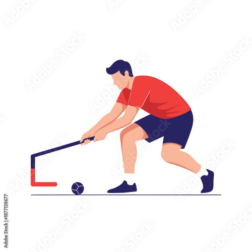 Athlete in a red shirt and blue shorts playing field hockey hitting a ball with a stick during a game or practice.