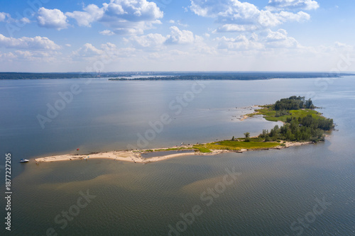 Aerial view of the island's sandy spit with forest and vacationing tourists