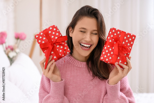 Happy young woman holding t...