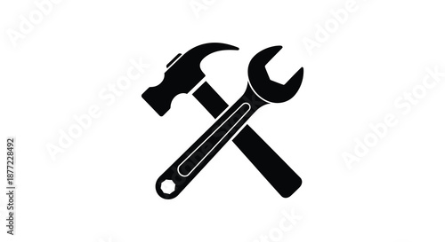 A striking depiction of crossed hammer and wrench tools in a dark silhouette