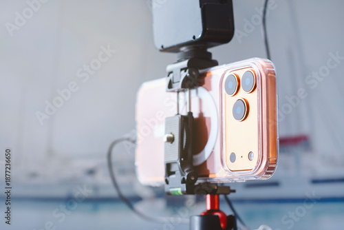 Photos Smartphone mounted on tripod with external microphone for video recording