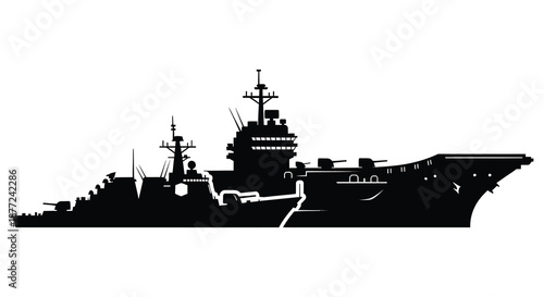 A striking black silhouette of a large naval battleship floating on calm waters silhouette