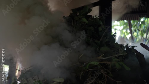 Burning branches and leaves in an old-fashioned kiln.