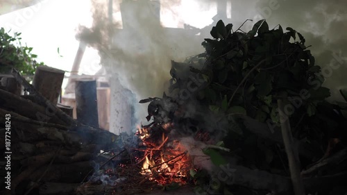 Burning branches and leaves in an old-fashioned kiln.
