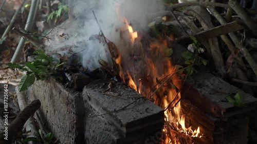 Burning branches and leaves in an old-fashioned kiln.
